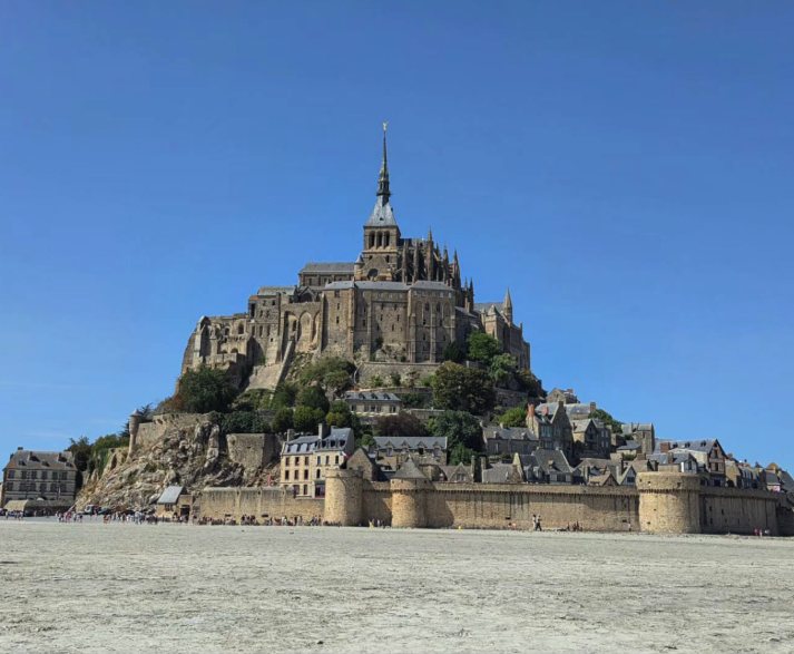 Mont Saint-Michel rising from the tidal flats, the fortified walls and village roofs below the abbey
