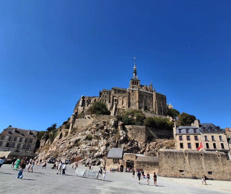The granite rock and the ramparts of Mont Saint-Michel seen from the esplanade at the entrance